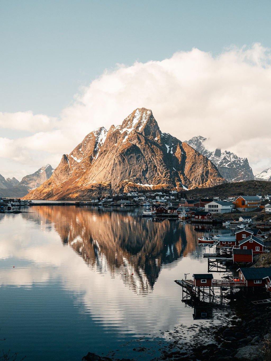 Mountains and cabins reflected in the waters of Lofoten