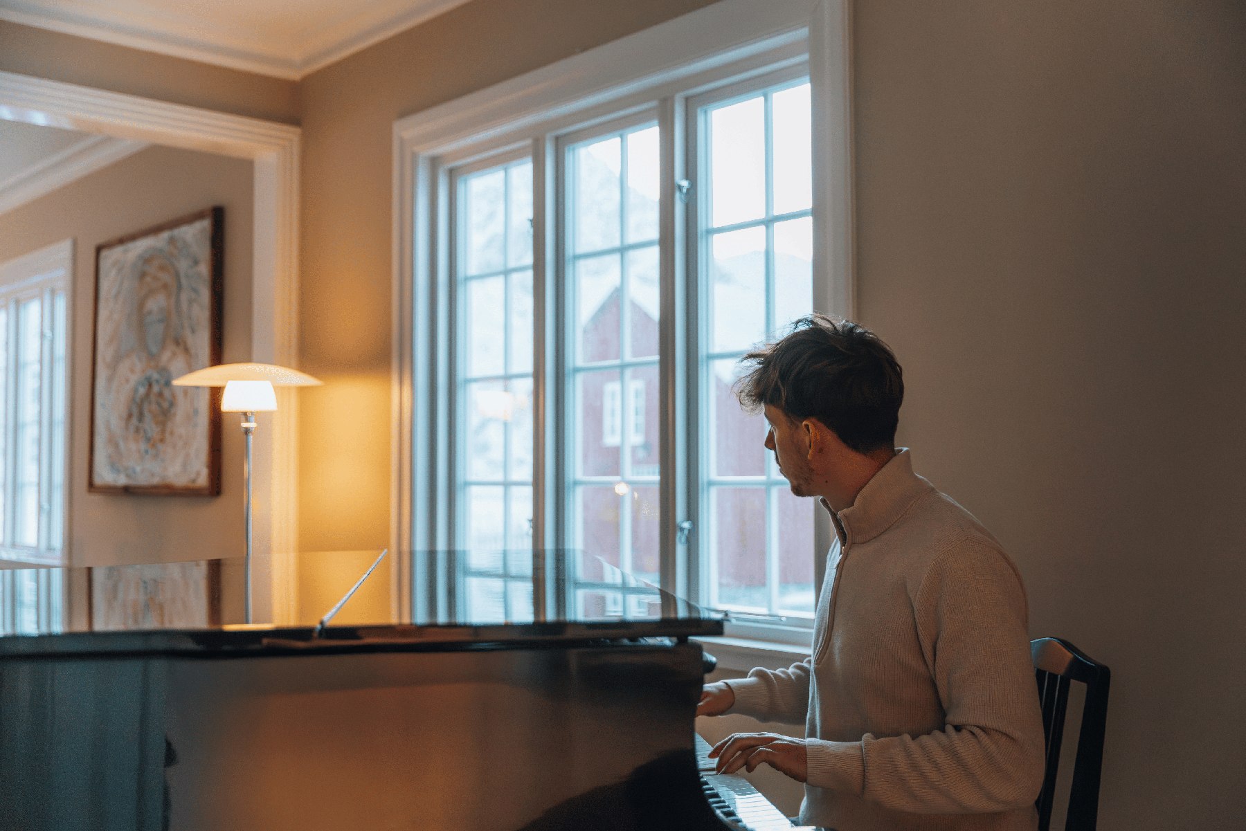 Playing piano in a bright living room